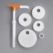 A white and orange Choice Condiment Pump adapter lid with a white circle and a hole in it.