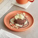 A chocolate dessert on an Acopa Terra Cotta matte coupe porcelain plate.