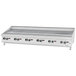 A white countertop with a Garland chrome griddle and knobs.