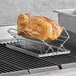 a cooked chicken on a metal rack