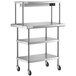 A stainless steel Regency work table with shelves on wheels.