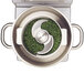 A stainless steel bowl with a blade inside it filled with green grass.