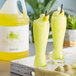 A tray of yellow Narvon Dew Drop slushy drinks.