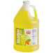 A jug of Carnival King Mountain Freeze slushy syrup with a yellow liquid and a label.