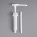 A white plastic pump with a white tube and cap.