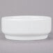 An Arcoroc white porcelain bowl on a gray surface.