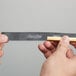 Hands holding a Unger ErgoTec Soft Rubber Squeegee Blade.