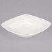 A CAC Garden State white square porcelain soup plate with a wavy design.