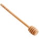 A Fox Run wooden honey dipper with a wooden handle.