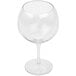 A close-up of a clear GET Social Club Tritan plastic gin and tonic glass with a stem.