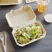 A salad in a Tellus Products paper container.