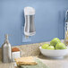 A Guardian Technologies Germ Guardian plug-in air sanitizer on a kitchen counter next to a bowl of green apples.