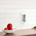 A Guardian Technologies Germ Guardian plug-in air sanitizer on a kitchen counter with a bowl of apples.