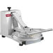 A white Estella manual pizza dough press with a black handle.