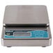 An Edlund Poseidon digital portion scale with a stainless steel body and blue screen.