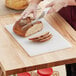 a person cutting bread with a knife