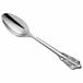 An Acopa Ophelia stainless steel serving spoon with an ornate handle.