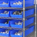 Regency blue plastic bins on a metal shelf.