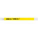 A neon yellow and white Tyvek wristband with black text reading "OVER 21"