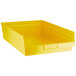 A yellow plastic Regency shelf bin.