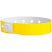 A yellow wristband with white dots.