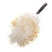 A lambswool duster with a black handle and fluffy white and yellow fibers.