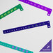 A group of purple Carnival King wristbands with white customizable text.