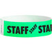 A mint green paper wristband with black "STAFF" text.