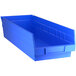 A Regency blue plastic shelf bin with a handle.