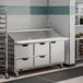 A Beverage-Air refrigerated sandwich prep table on a large counter in a commercial kitchen.