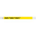A yellow Tyvek wristband with black text that reads "STAFF"