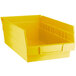 A yellow Regency plastic shelf bin.
