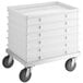 A stack of white plastic bins on wheels.