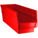 A close-up of a red plastic Regency shelf bin.