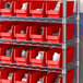 A shelf with Regency red bins filled with white objects.