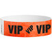 A red Tyvek wristband with black "VIP" text.