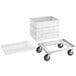 A white plastic dough proofing container with a white lid on a white metal dolly.