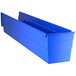 A blue plastic Regency shelf bin with open compartments.