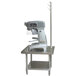 An Advance Tabco mixer on a stainless steel table with utensil rack and undershelf.