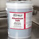 A 5 gallon bucket of Noble Chemical Metal Safe dishwashing liquid on a counter.