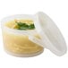 A clear plastic container with a lid and a soup container with a clear handle inside.