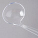 A clear plastic ladle with a long handle.