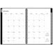 A spiral bound Blue Sky monthly planner for January 2024 - December 2024 with black text on a white background.