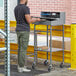 A man standing at a Lavex Mobile receiving desk with a computer on it.