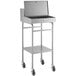 A silver rolling Lavex receiving desk with a shelf and a drawer on wheels.