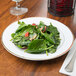 A CAC Golden Royal porcelain plate with a salad on a table.