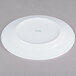A CAC white porcelain plate with a green logo on it.