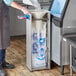 A person using a Choice ice bagger to fill a white bowl with ice.