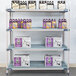 A MetroMax i open grid shelf with removable mat holding boxes and bottles of beer.