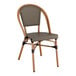 A brown Lancaster Table & Seating outdoor side chair with a wooden frame.